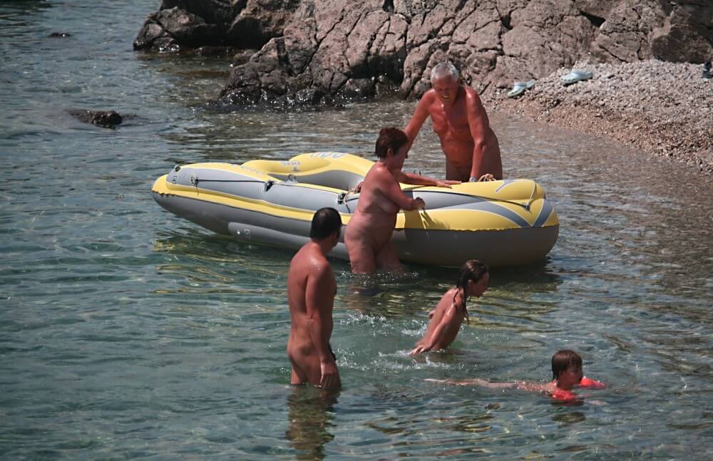 Lone Nudist in Yellow Boat photos - Naturism and nudism
